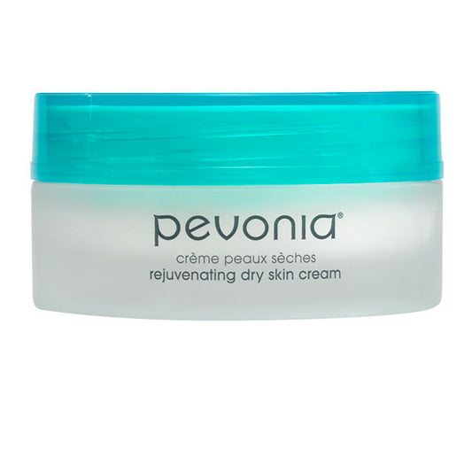A jar of Pevonia rejuvenating dry skin cream with a green lid on a white background.