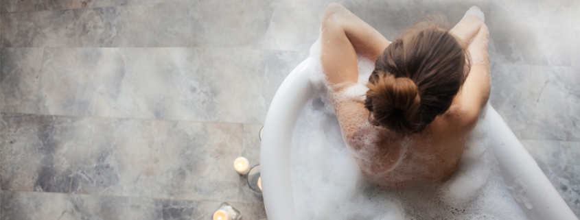 self care at home, woman enjoying a nice soak in a tub