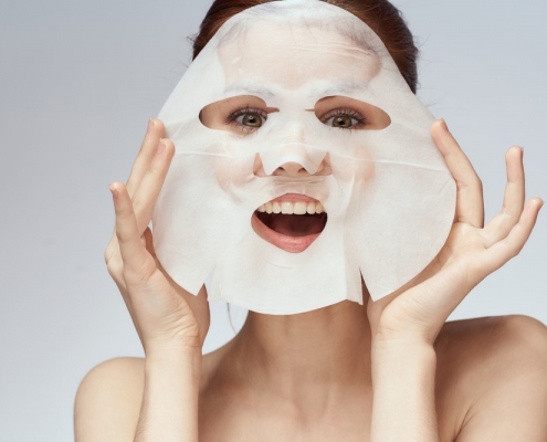 woman with sheet mask on her face