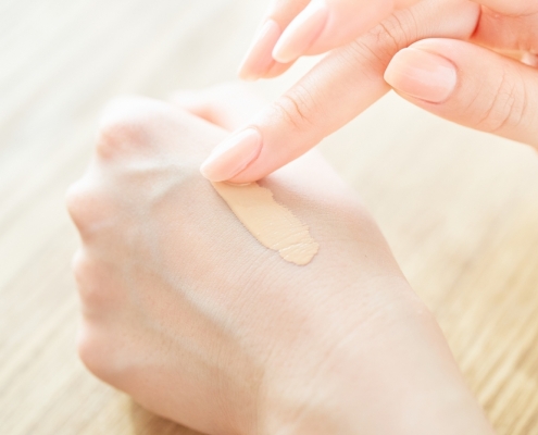 applying BB Cream on a woman's hand to test it
