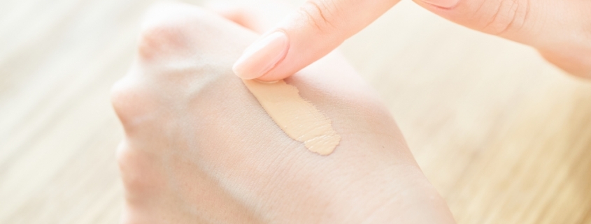 applying BB Cream on a woman's hand to test it