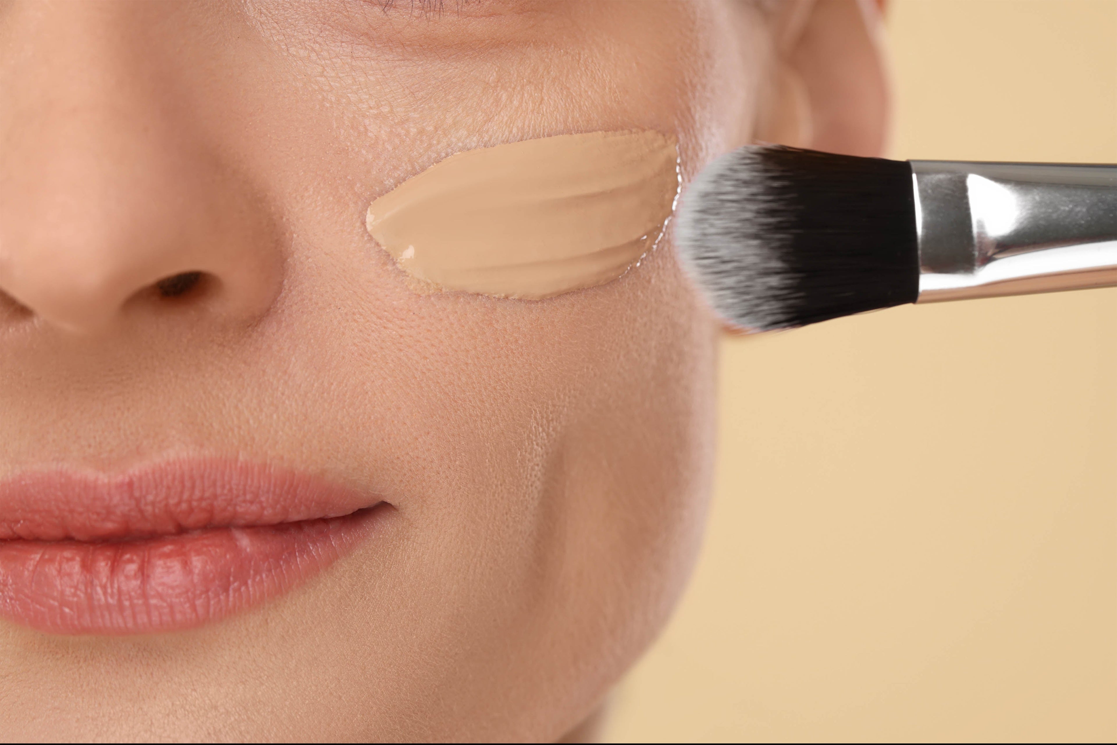liquid foundation being applied to cheek