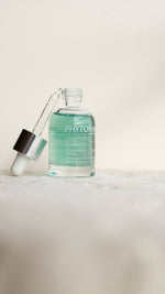 Bottle of Phytomer serum with dropper on a light background