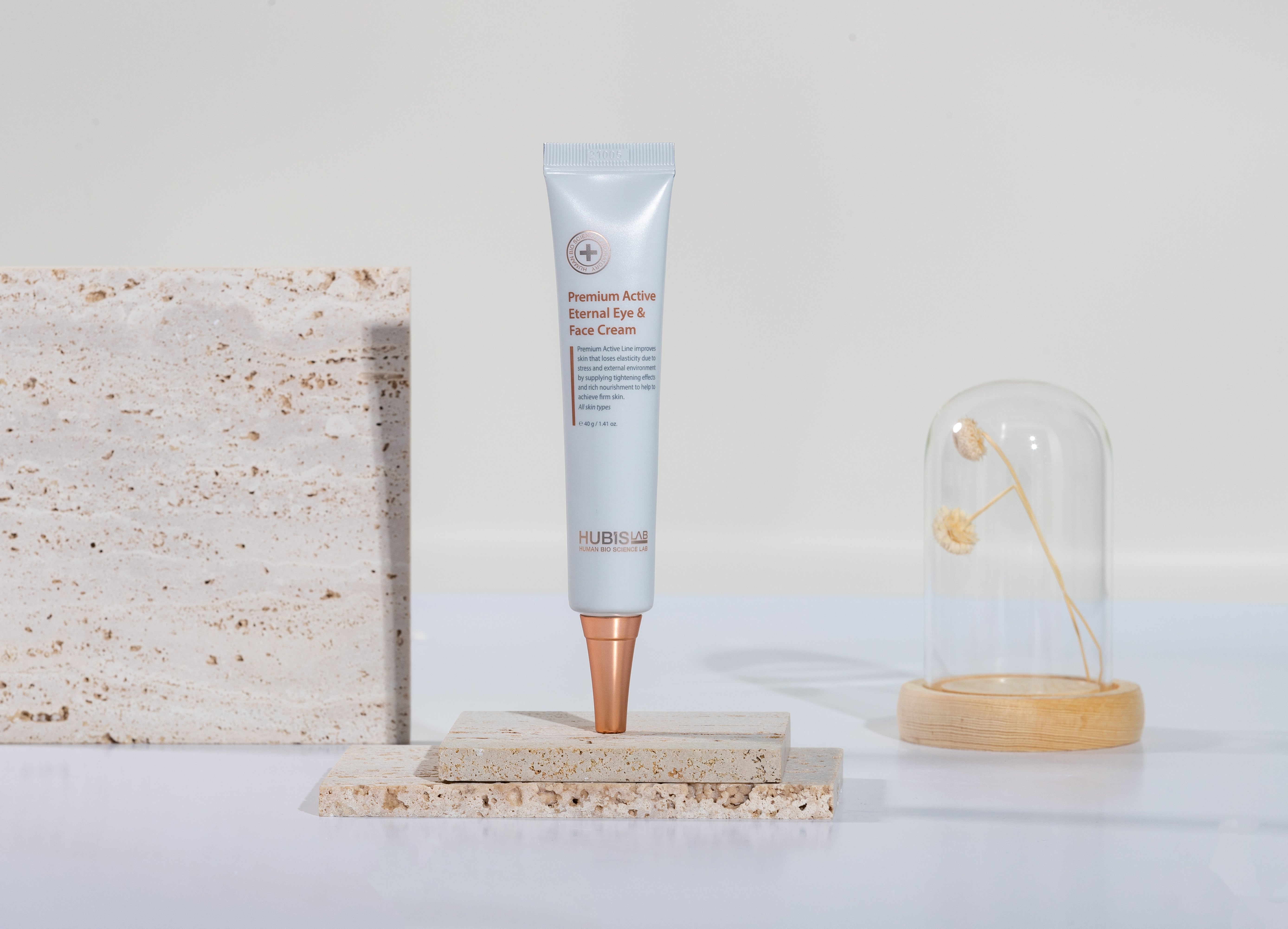 A tube of Hubislab A tube of Hubislab Premium Active Eternal Eye & Face Cream next to its packaging box.