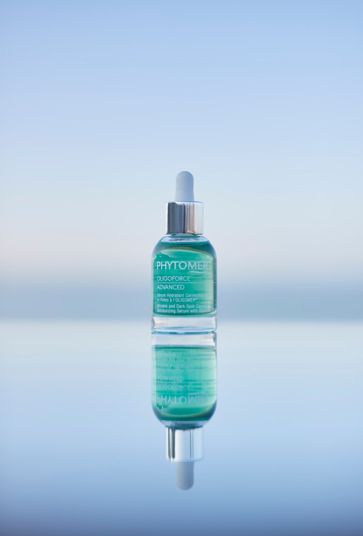 Bottle of Phytomer Oligoforce Advanced Serum 30ml on a gradient blue background
