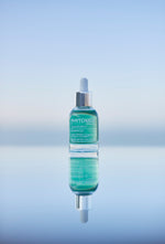 Bottle of Phytomer skincare serum on a gradient blue background
