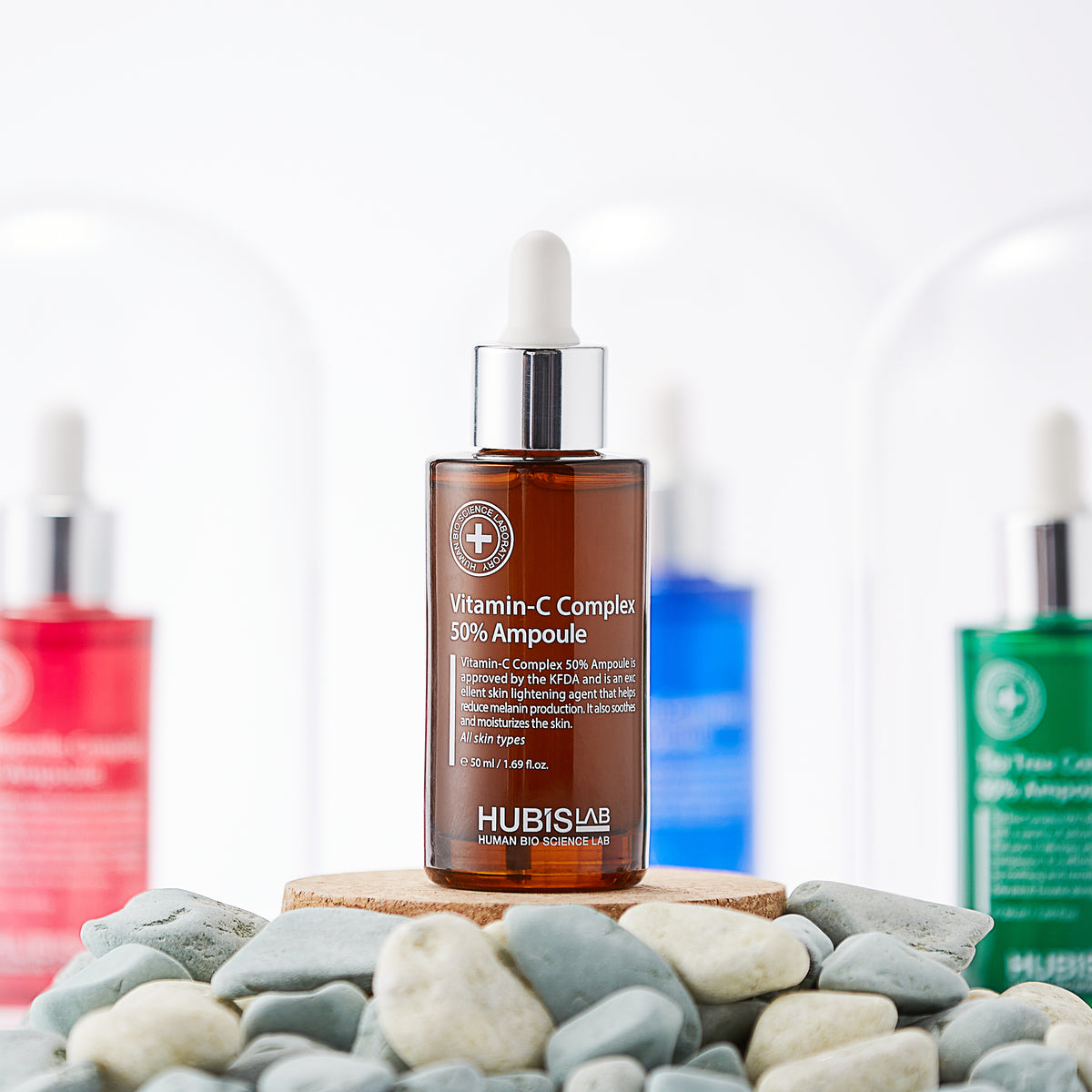 Hubislab Derma Max Vitamin-C Complex 50% Ampoule 50ml displayed on a bed of pebble rocks 