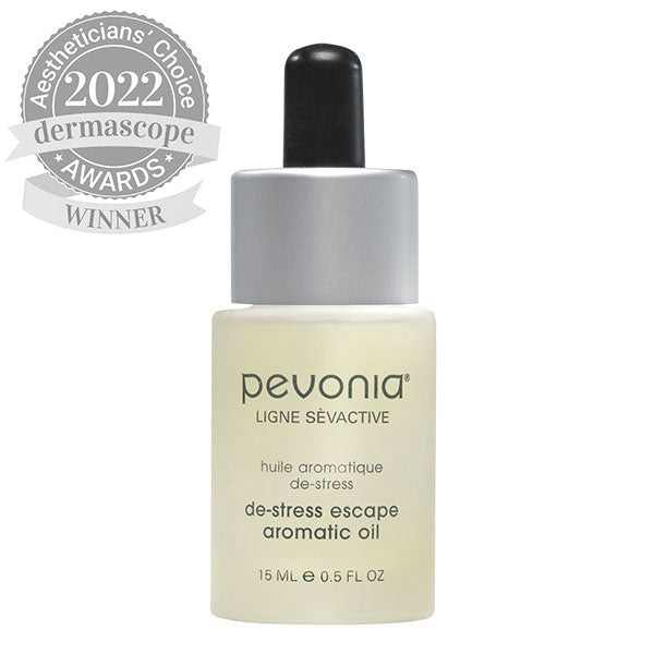 A bottle of Pevonia De-Stress Escape Aromatic Oil with a label indicating that it is a winner of the 2022 Dermascope award.