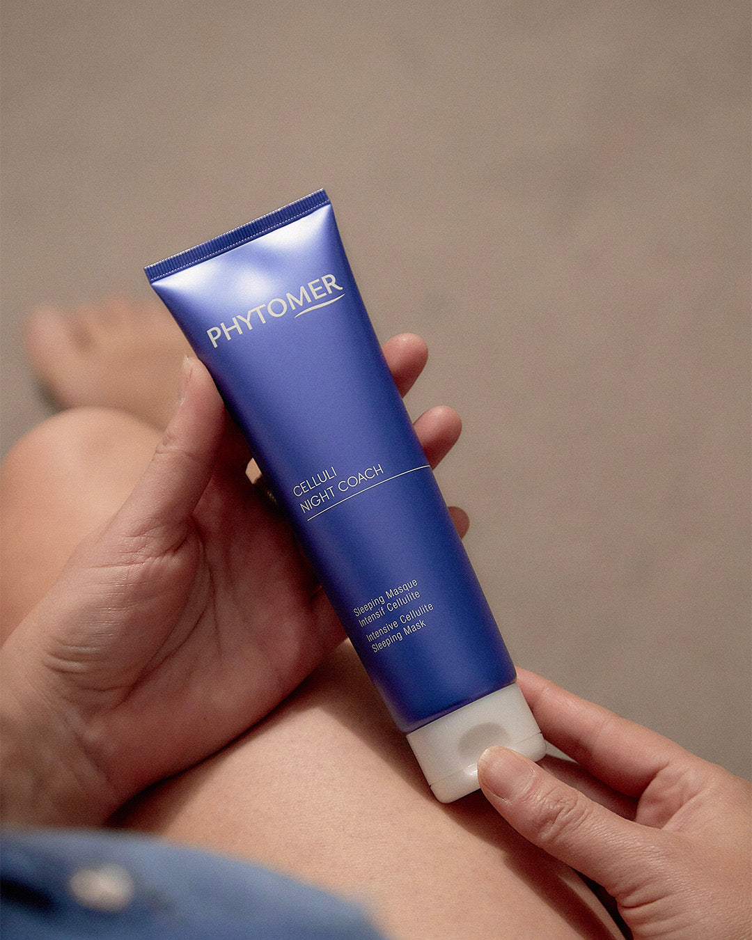 Woman holding PHYTOMER Celluli Night Coach Intensive Cellulite Sleeping Mask in her hands 