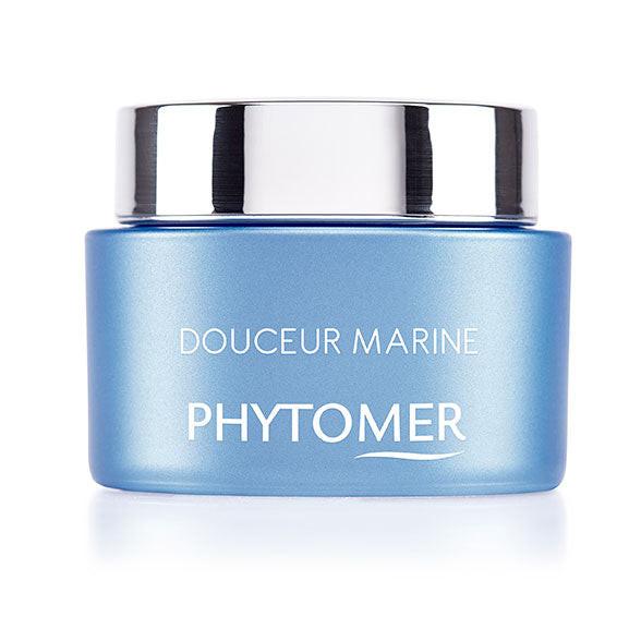 Blue jar with silver lid labeled 'Douceur Marine Phytomer' on a white background