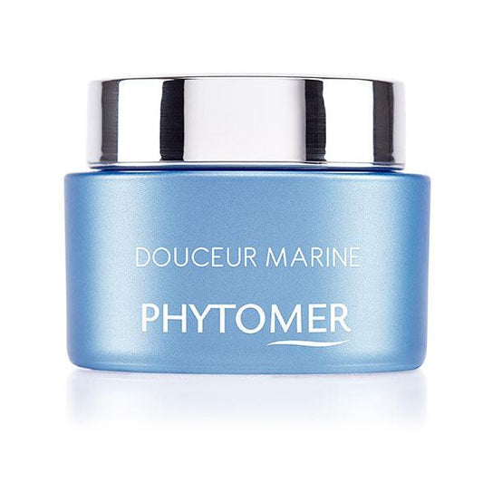 Blue jar with silver lid labeled 'Douceur Marine Phytomer' on a white background
