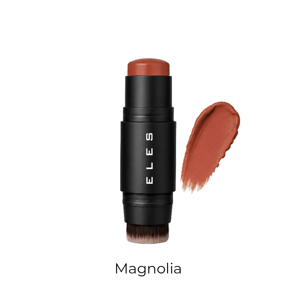An ELLES makeup stick in the shade Magnolia, featuring a matte black barrel with white brand lettering and a warm terracotta-brown cosmetic product exposed at the top. A matching textured swipe of the cream product is shown to the right, with the shade name 'Magnolia' printed below on a clean white background.