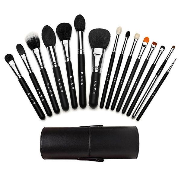 Set of makeup brushes with black handles and silver ferrules, arranged in a semi-circle on a white background. A black leather case is in front.