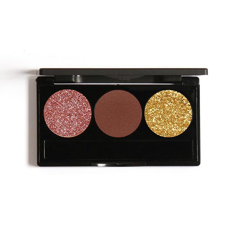 A black eyeshadow palette with three shades: a matte pink, a shimmering gold, and a bronze contoured cheek, all contained in a black case.