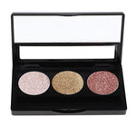 A palette containing three different shades of eyeshadow, with a reflective surface and matte finish.
