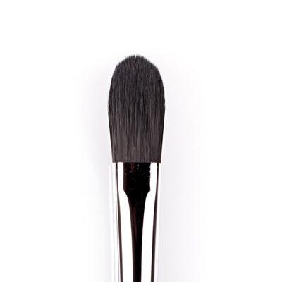 Makeup brush with black bristles on a white background