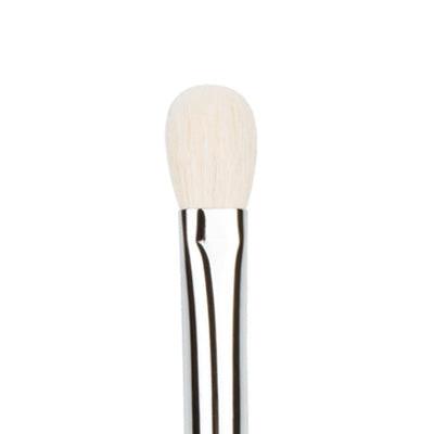 Makeup brush with white bristle head and black handle on a white background