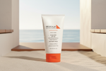 Tube of Medicalia Skincare sunscreen on a sandy surface with a beach background