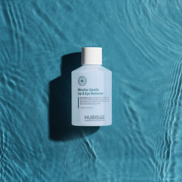 Bottle of Hubislab pure balance Micellar Gentle Lip & Eye Remover on a textured blue background