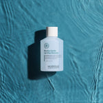 Bottle of Hubislab pure balance Micellar Gentle Lip & Eye Remover on a textured blue background
