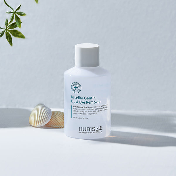 Bottle of Hubislab_pure_balance Micellar Gentle Lip & Eye Remover on a light background with a shell and plant.