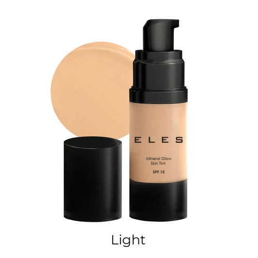 Foundation bottle with applicator and shade swatch on a white background
