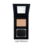 Compact powder in a black case with a mirror on a white background