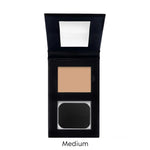 Compact makeup powder in a black case with a mirror on a white background