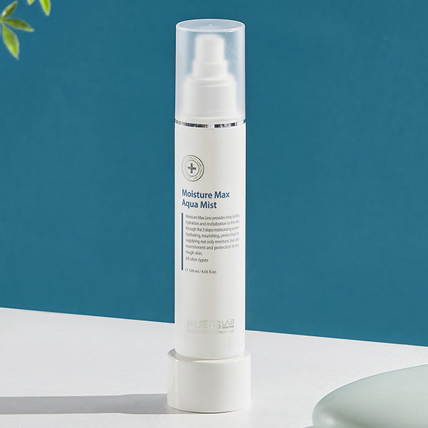 Moisture Max Aqua Mist bottle on a white surface with a blue background