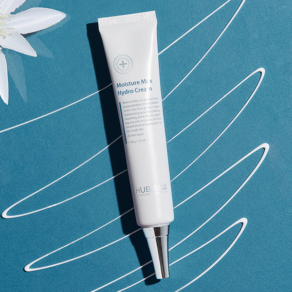Moisture Max Hydro Cream 40g on a blue background with white cream elements