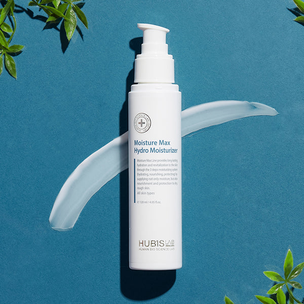 Moisture Max Hydro Moisturizer bottle with green leaves on a blue background