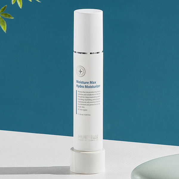 Skincare bottle labeled 'Moisture Max Hydro Moisturizer' on a white surface with a blue background