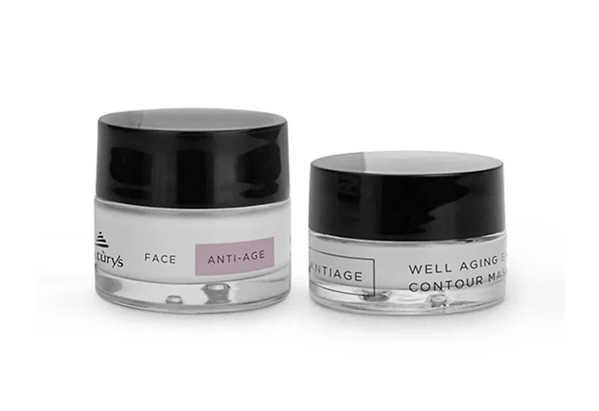 Two skincare jars with black lids on a white background