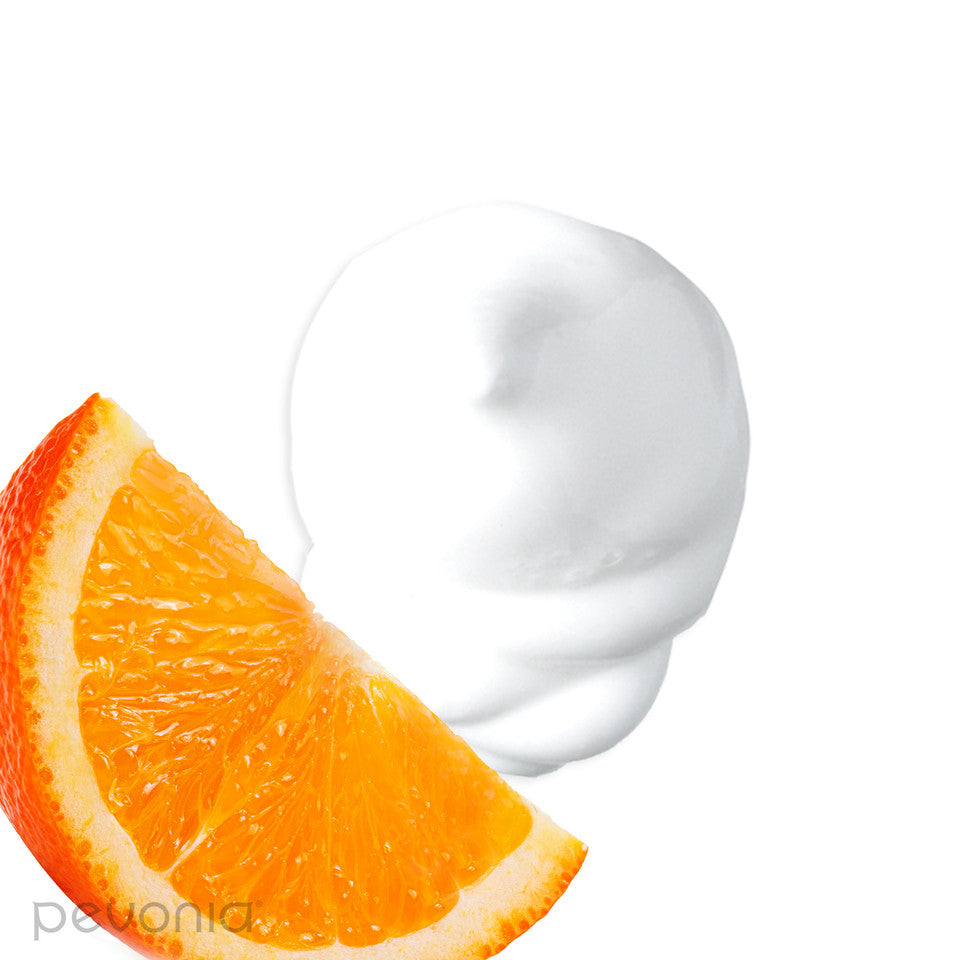 pevonia micro-emulsified massage oil anti-stress showing orange slice and white cream on a white background texture and ingredients