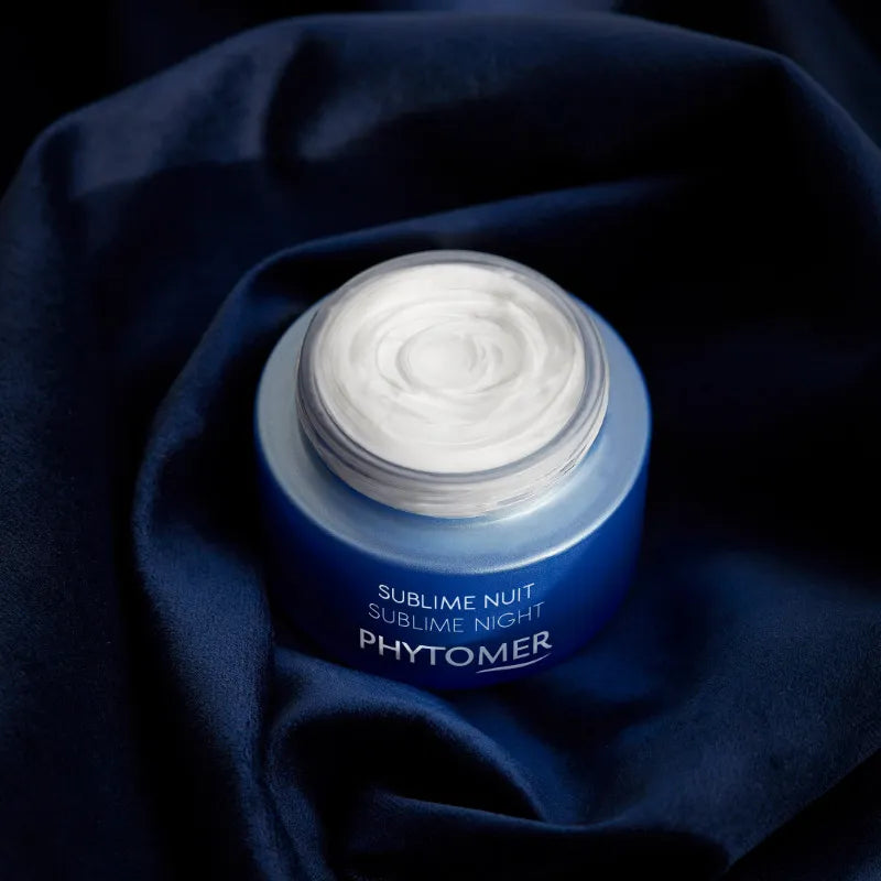 Phytomer Sublime Nuit cream jar on a dark blue fabric background