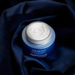 Phytomer Sublime Nuit cream jar on a dark blue fabric background