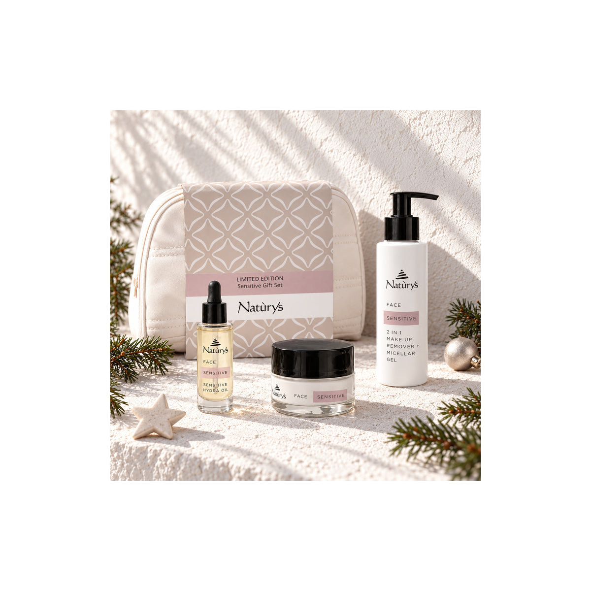 Naturys Sensitive micellar gel, facial oil, cream and white cosmetics bag in a sunlit Christmas setting with pine sprigs and ornaments.