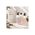 Naturys Silky Skin boxed body set with shower gel, peel and body cream in a Christmas setting with pine sprigs and ornaments.