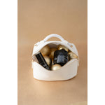 Time Control cream and Hydra Volume lip serum in a white Vie Collection pouch with gold Christmas decorations
