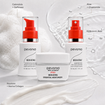 Woman applying Pevonia Micro-Retinol Essential Moisturiser in a home bathroom with the Foaming Cleanser and Toner displayed on the stone vanity.