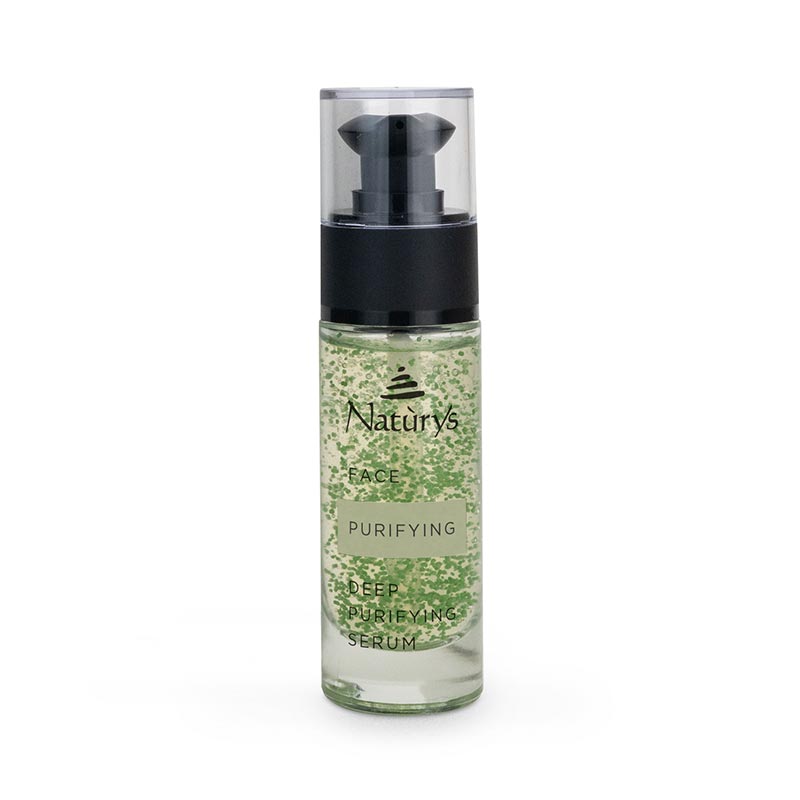 A clear glass bottle with a black pump dispenser containing a green liquid, labeled as 'Naturys Deep Purifying Serum'.