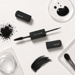 Eles 2 in 1 Mascara Liner Black arranged on a white surface, including a mascara tube, eyeliner wand, eyeliner cap, powder, brush, and clear containers. The central product is the black eyeliner wand with the brand name ELES visible on the tube.