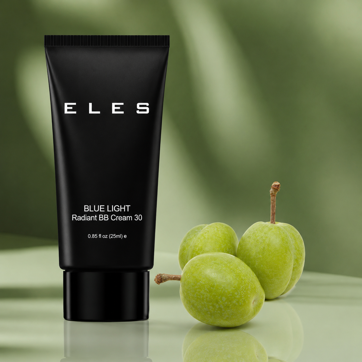 ELES Blue Light Radiant BB Cream 30 tube displayed with green plum fruit on a soft green background.