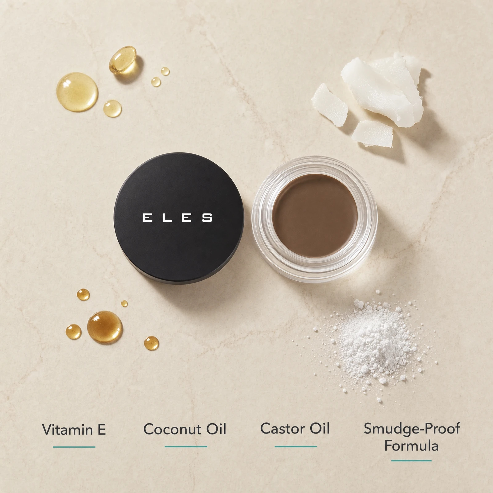 ELES Brow Balm Pomade ingredient flatlay featuring vitamin E, coconut oil, castor oil and smudge-proof formula on a warm limestone surface