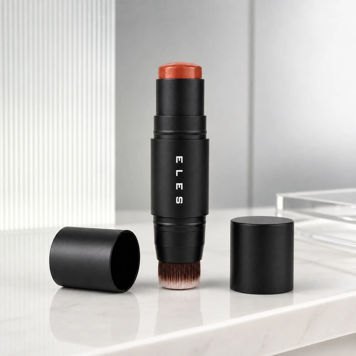 A Cheek & Lip Cream Blush 7g, standing upright on a white marble surface. The brand name 'ELES' is printed vertically on the tube.