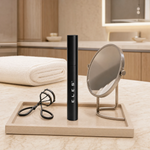ELES Lash Fortify Mascara Black standing upright on a stone tray with a lash curler and round mirror on a marble clinic bench inside a premium skin clinic treatment room, ideal for professional lash and eye finishing after facial treatments