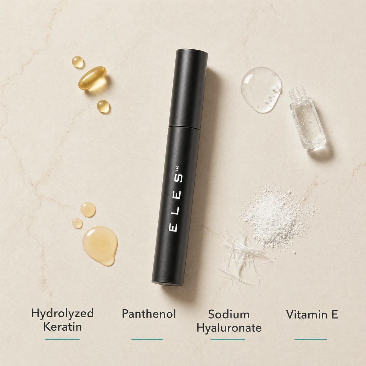 ELES Lash Fortify Mascara Black ingredient flatlay featuring hydrolyzed keratin, panthenol, sodium hyaluronate and vitamin E on a warm limestone surface