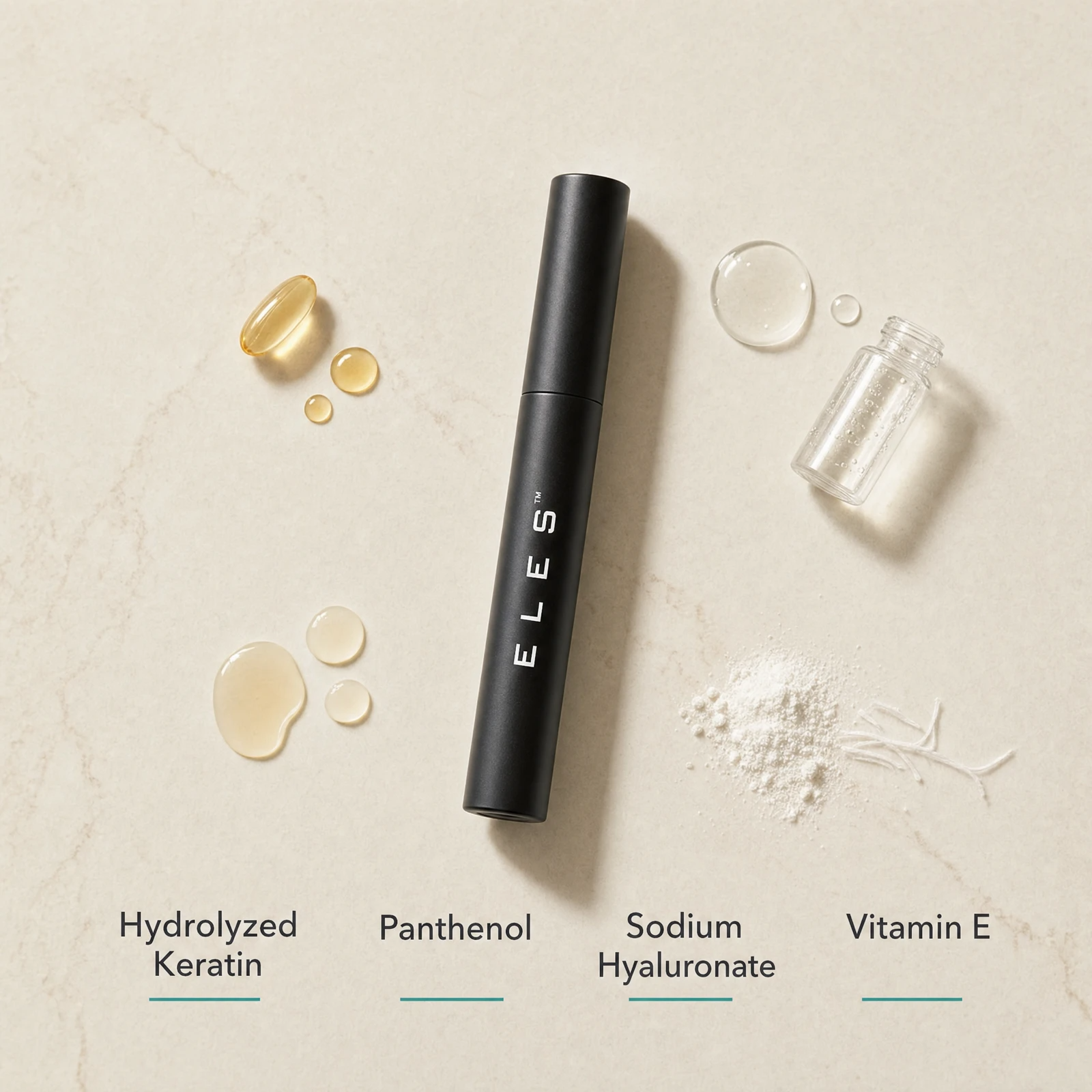 ELES Lash Fortify Waterproof Mascara Black ingredient flatlay featuring hydrolyzed keratin, panthenol, sodium hyaluronate and vitamin E on a warm limestone surface