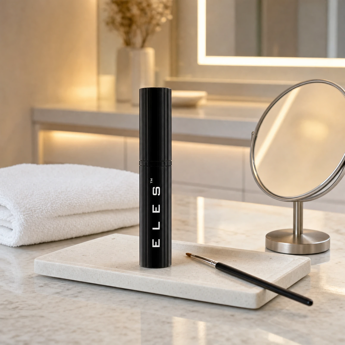 ELES Mineral Photo Touch Concealer standing upright on a stone tray with a concealer brush and round mirror on a marble clinic bench inside a premium skin clinic treatment room, ideal for professional post-facial concealer and brightening application