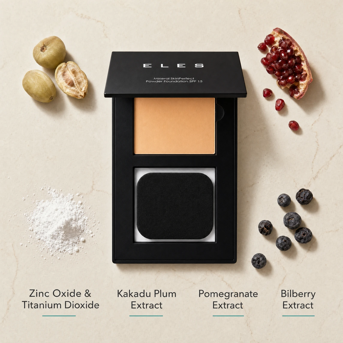 ELES Mineral SkinPerfect Powder Foundation SPF 15 ingredient flatlay featuring zinc oxide and titanium dioxide, Kakadu plum extract, pomegranate extract and bilberry extract on a warm limestone surface